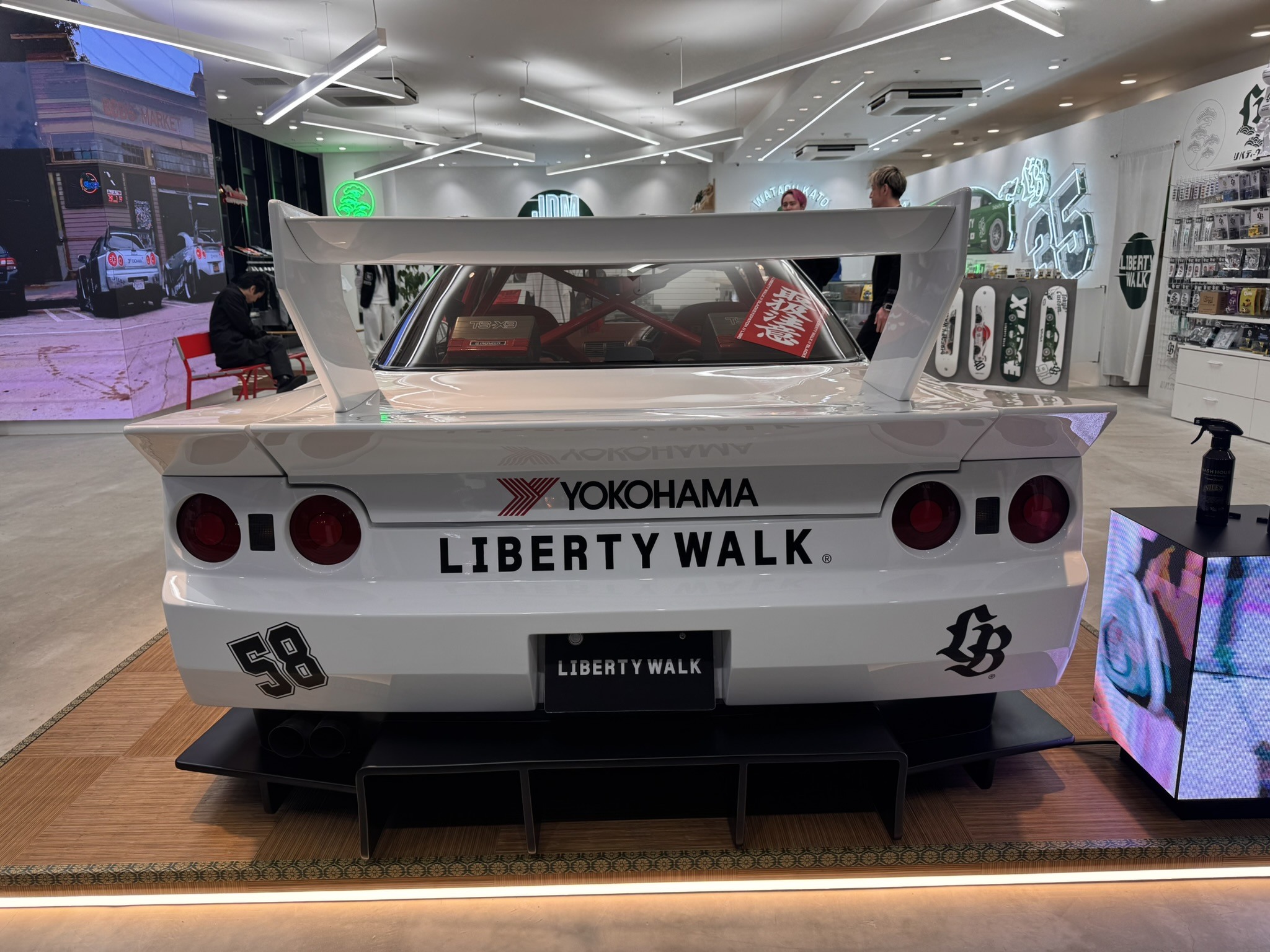 Rear view of a modified car inside a Tokyo shop.