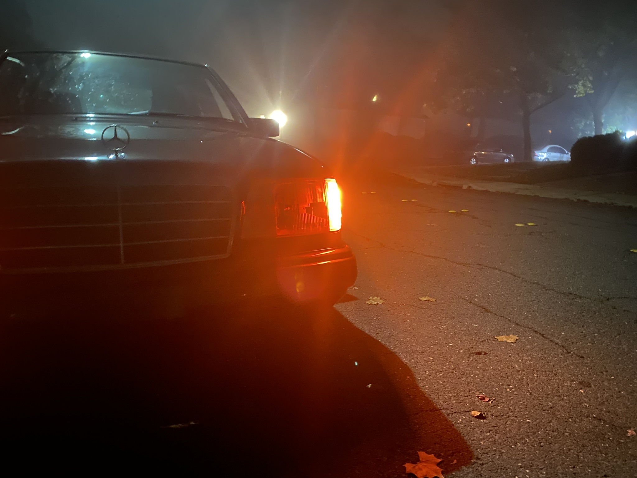 Close view of a glowing amber turn signal at night.